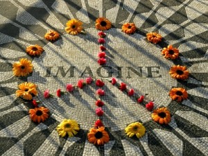 a-makeshift-peace-sign-of-flowers-lies-on-top-john-lennon-s-strawberry-fields-memorial
